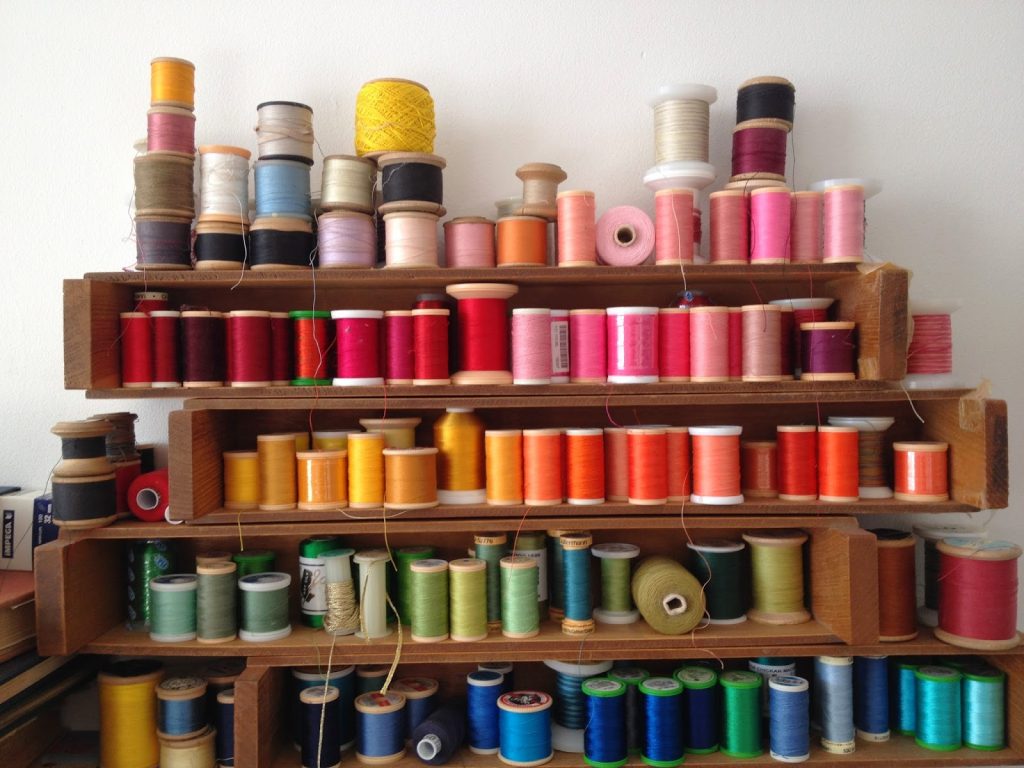 vintage, wooden cotton reel on thread rack
