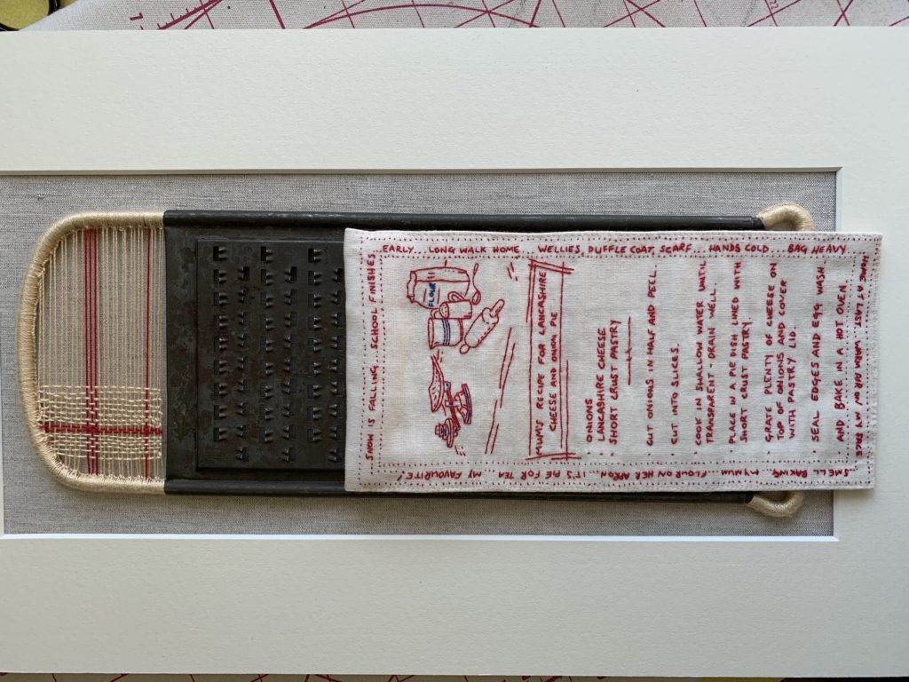 Open Door Exhibition 2020 - An embroidered textile art piece in red thread on white cloth, displayed on a cheese grater. An embroidered artwork based on my Mum's own recipe - a childhood favourite of mine.