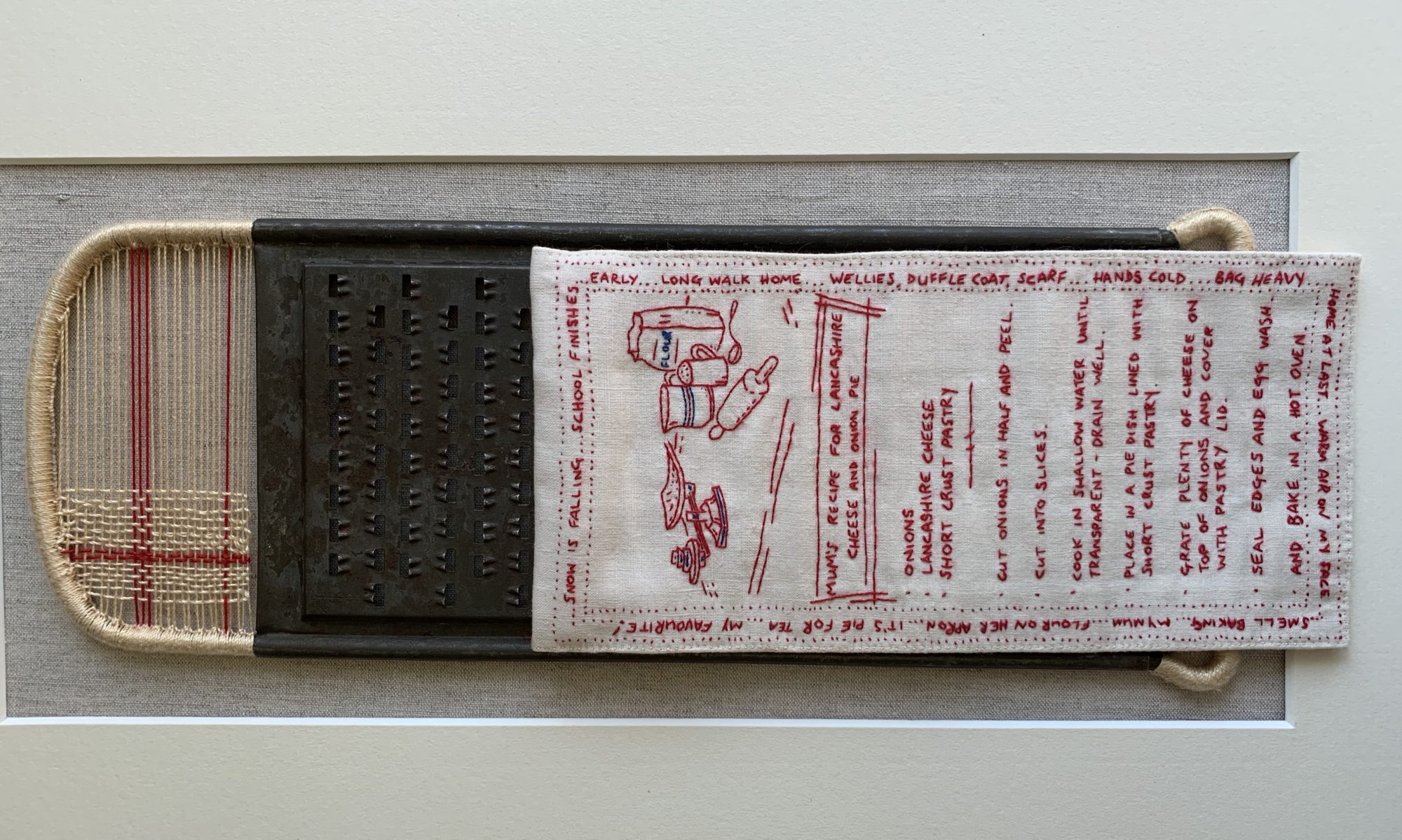 Open Door Exhibition 2020 - An embroidered textile art piece in red thread on white cloth, displayed on a cheese grater. An embroidered artwork based on my Mum's own recipe - a childhood favourite of mine.
