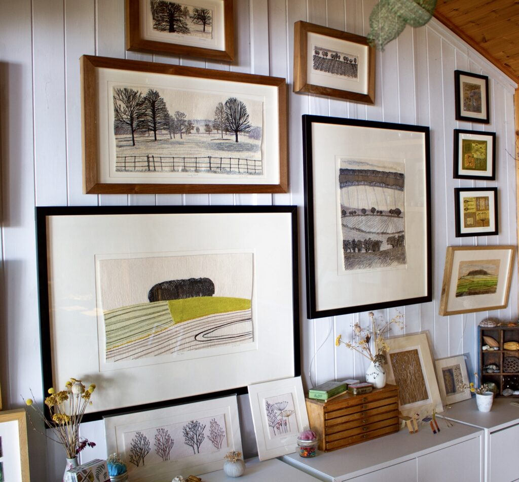Embroidered Landscapes - a wall of embroidered art work in a studio
