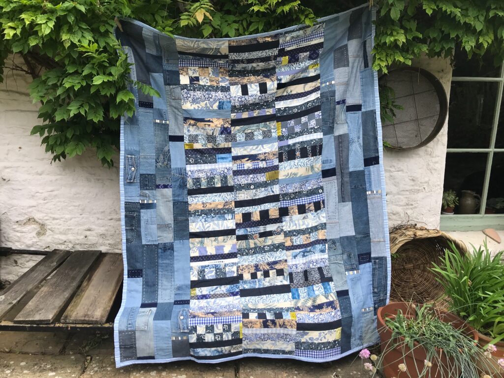 patchwork quilt made from old denim jeans and other cotton cloth by Christine Green