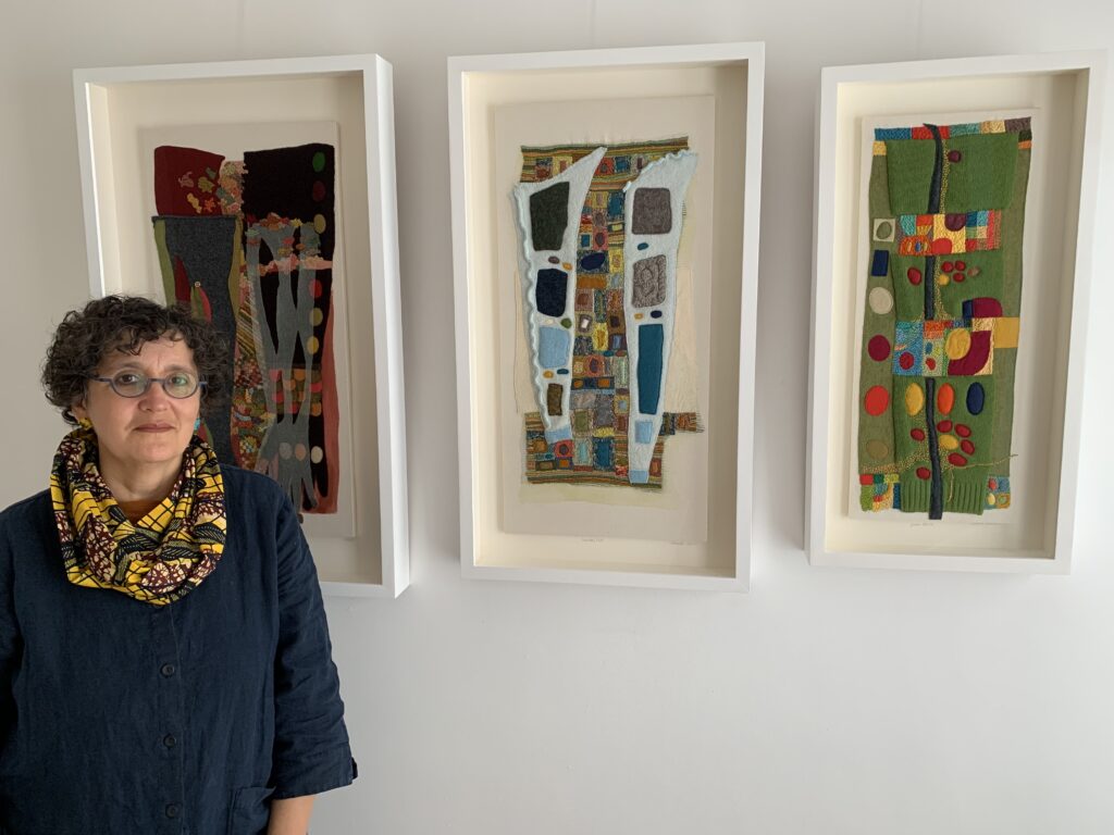 Sabine Kaner standing in front of her work