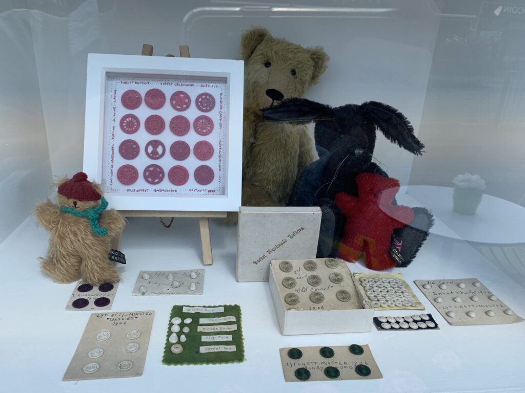 dorset buttons displayed on cards and in frames. red and natural colours, old  and modenn