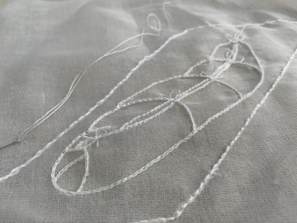 Collateral Project - hand embroidered white thread on silk organza - image of the outline of a body wrapped in cloth