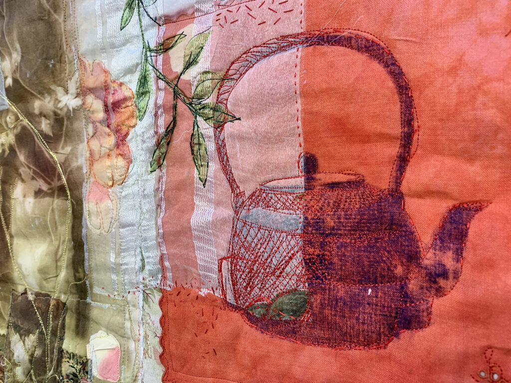 Machine embroidered kettle on a red cloth by Cas Holmes