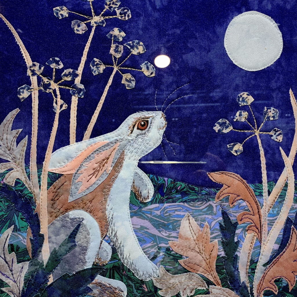 Hare looking at the full moon created in fabric and stitch by Kate Findlay