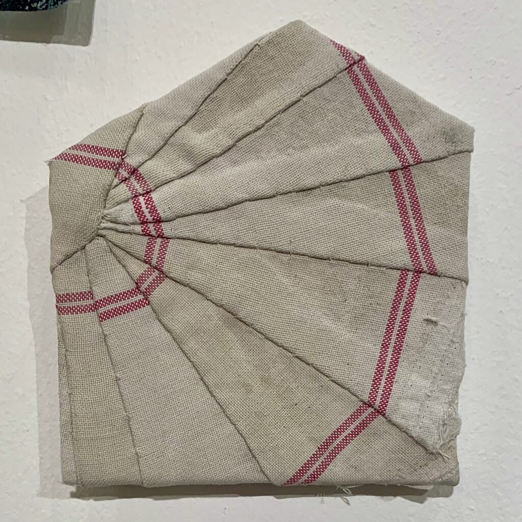 House shape covered in a fan of cloth made from an old striped cotton tea cloth by Hannah Lamb