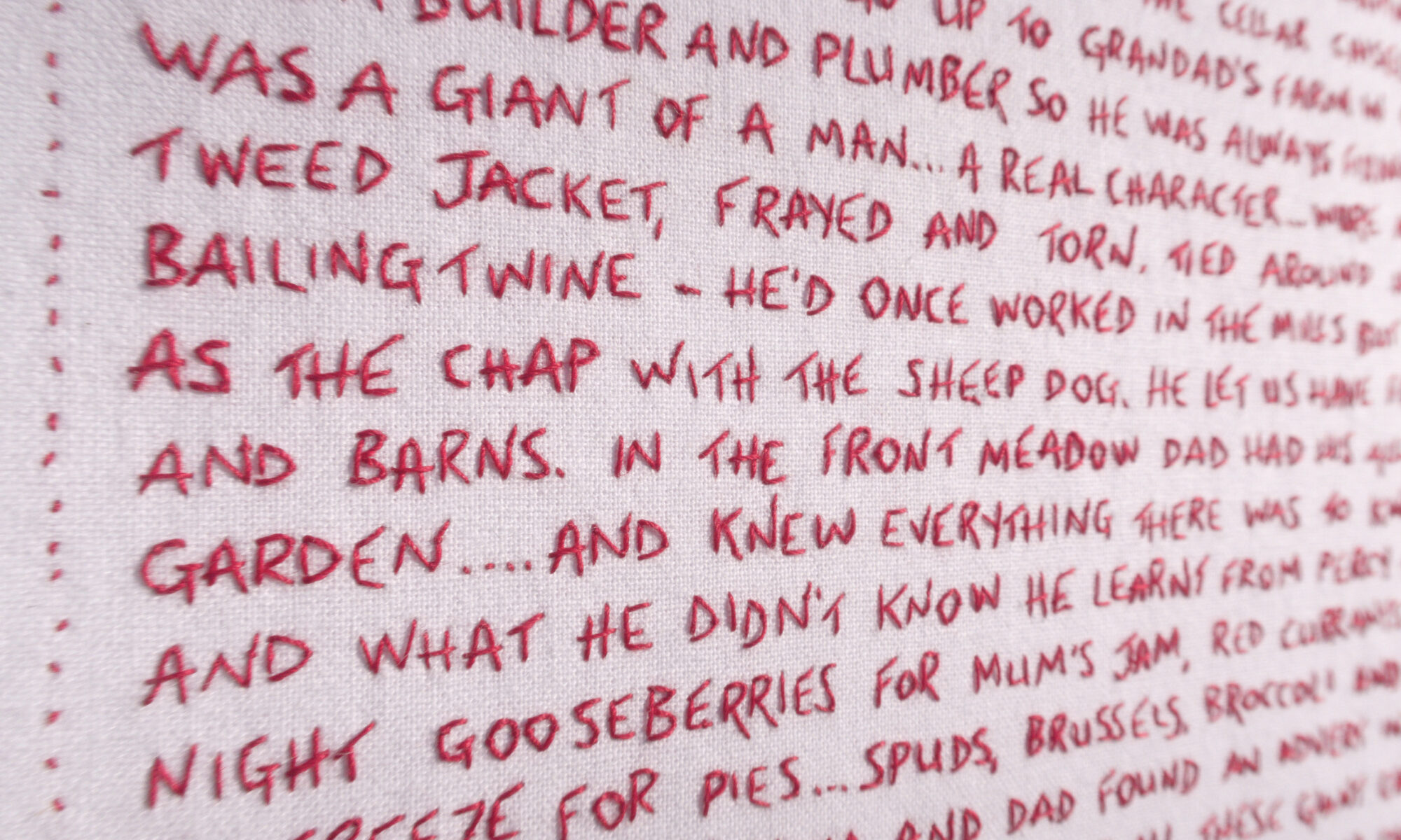 Close up of the stitching - Giant Cauliflower Harvest - embroidered word, red thread about my father and his allotment