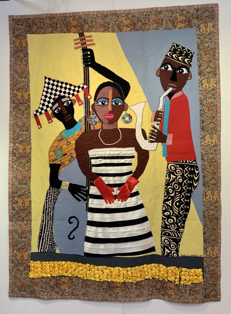 Patchwork quilt by Micheal Cummings featuring musicians