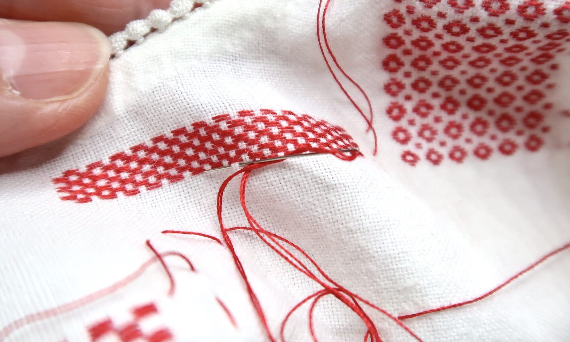 Darning Sampler - hand stitched red thread into a vintage white child's garment