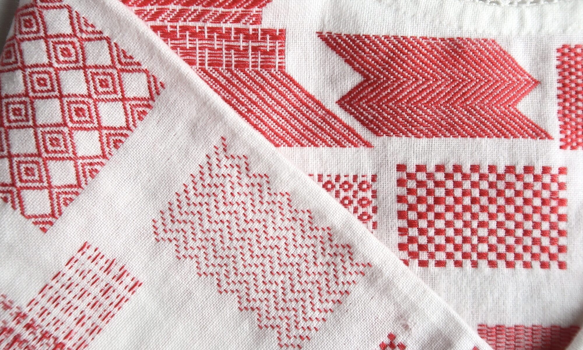 Darning Sampler - hand stitched red thread into a vintage white child's garment